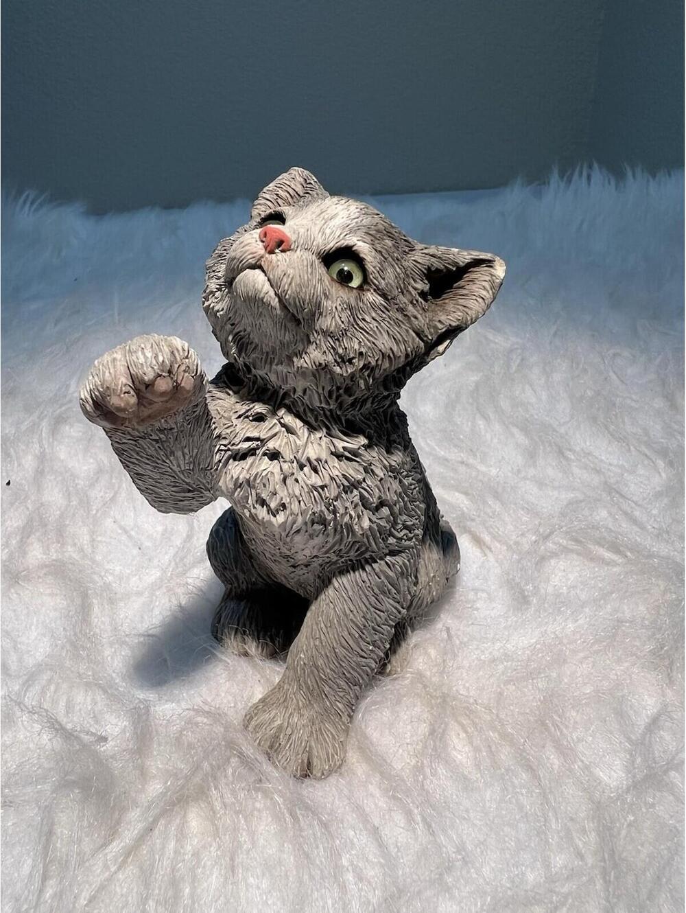 gray resin cat figurine with green glass eyes